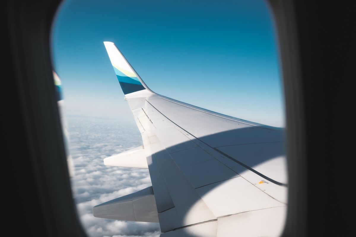 Internationaler Haustausch: Blick aus dem Flugzeugfenster über den Wolken